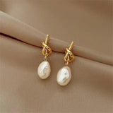Gold Earrings Adorned with Baroque Pearls